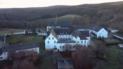 Flyby-of-the-Trappist-Monastery-Mariawald-Abbey-in-Germany,-Drone-shot