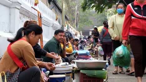 Luang-Prabang-morning-market-is-the-market-located-in-the-world-heritage-city-of-Luang-Prabang,-they-use-alley-beside-the-temple-to-sell-their-goods-such-as-fresh-vegetable,-fish,-and-wild-animal