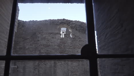 Reflejo-De-Los-Turistas-En-El-Coliseo-Desde-Una-Ventana-En-Roma,-Italia