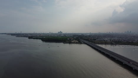 aerial-view-of-the-Suramadu-bridge,-the-longest-bridge-in-Indonesia-connecting-the-islands-of-Java-and-Madura