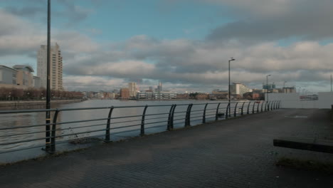 Pan-shot-of-a-pleasure-boat-in-front-of-the-lowry-center-at-Salford-keys