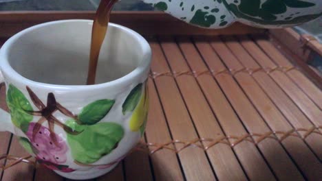 pouring-black-coffee-to-a-creamic-cup-from-enamel-teapot-best-footage