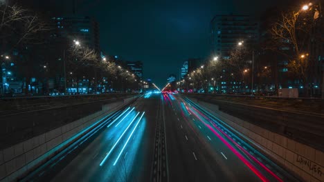 4K-time-lapse-taken-at-night-in-a-business-district-of-cars-passing-through-a-tunnel-in-the-centre-of-Madrid,-Spain