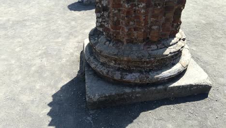 Close-up-around-the-remains-of-a-carved-stone-column-in-the-historic-city-of-Pompeii