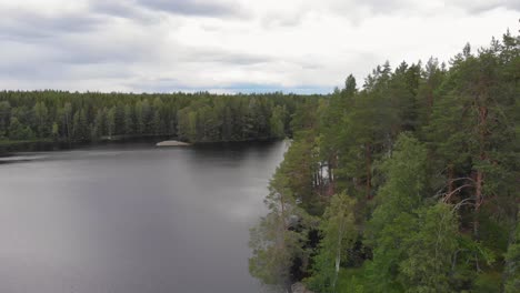 Aerial-view-of-lake-Nedre-Dammen-in-Gammelstilla,-Gästrikland,-Sweden-with-the-small-island-outside-Skoludden