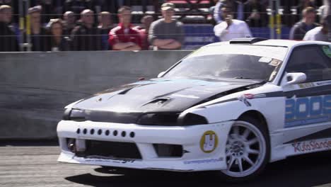 Close-shot-of-a-Nissan-Skyline-R32-drift-car-drifting-fast-into-a-corner-in-super-slow-motion