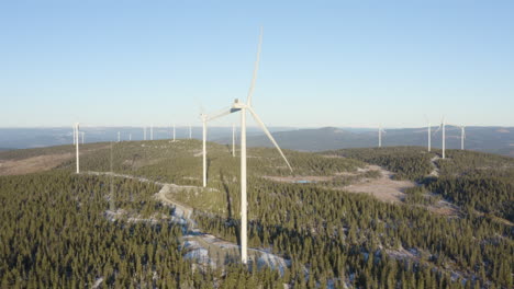 The-Powerful-Windmills-Spinning-And-Harvesting-Wind-Energy-In-Osen,-Norway-On-A-Sunny-Day---Aerial-Shot