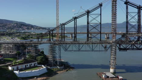 Hercilio-Luz-Bridge-under-restoration-works-connected-to-Auckland,-aerial-shot