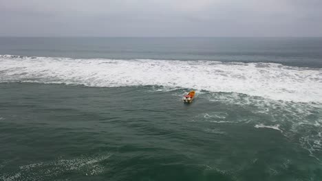 fishing-boat-going-fishing-on-a-day-of-swells-on-the-coast-of-chile-bucalemu-recording-of-a-drone