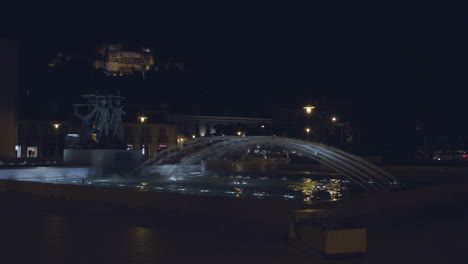 The-beautiful-and-stunning-water-fountain-in-the-peaceful-downtown-Leiria,-Portugal-during-the-night---Wide-shot