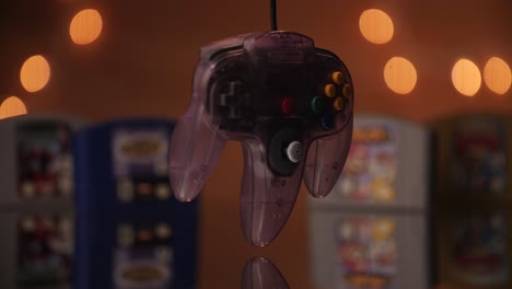 A-Nintendo-controller-spinning-with-N64-games-in-the-background