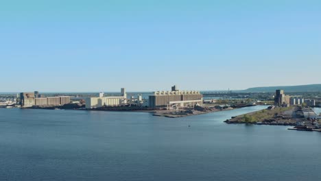 Aerial-view-waterfront-grain-storage-facilities-off-of-Lake-Superior-in-Duluth,-Minnesota---drone-flying-shot-high-angle-day