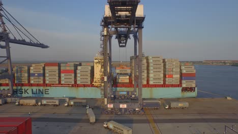 Aerial-shot-of-a-crane-lifting-a-container-in-a-port