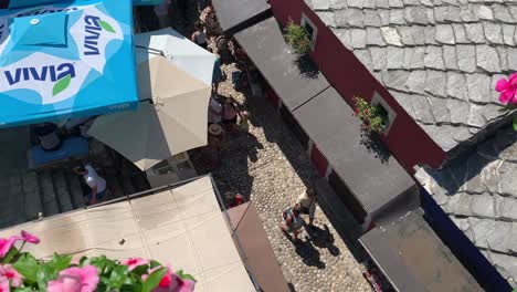 People-walking-through-narrow-streets-of-Mostar-old-town