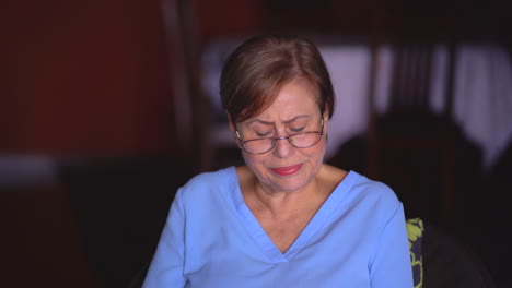 Grandmother-reading-at-home-starts-coughing