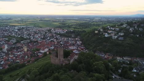 Descending-view-over-Strahlenburg-castle-in-Schriesheim-in-Germany-during-beautiful-sunset-with-view-below-of-city