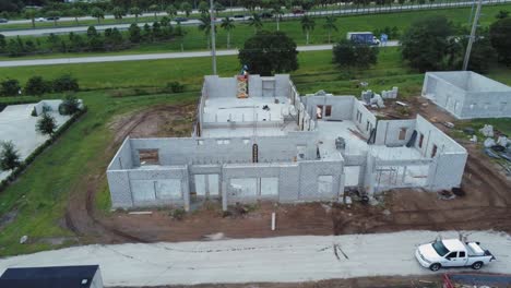 Aerial-overhead-view-of-building-being-constructed-along-interstate