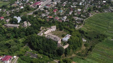 Aerial-View-of-Old-Abandoned-Building-Surrounded-by-Neighborhood-and-Trees