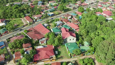 Angled-Aerial-of-Tropical-Town-and-Busy-Road-in-Batangas,-Philippines-4K