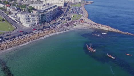 Aerial-Top-Down-Shot-of-Viking-Ship-Landing-on-Salthill-Beach,-Galway