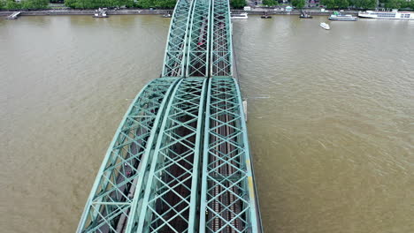 Aerial-shot-of-drone-flying-above-the-Rhine-river-towards-the-Cologne-Cathedral