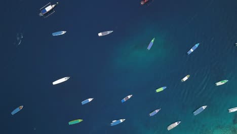 Aerial-top-still-shot-of-boats-over-the-turquoise-water-of-the-pacific-ocean-in-Bali