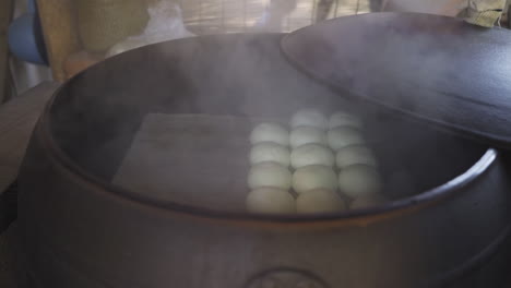 Homemade-red-bean-bun,-sold-in-Nami-Island,-South-Korea,-steamed-in-an-old-iron-stove,-medium-track-right-in-slow-motion