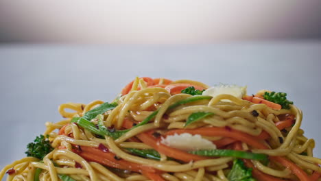 Broccoli-falling-on-top-of-spaghetti,-slow-motion