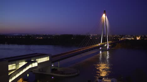 Vienna-subway-passing-impressive-Donaustadt-bridge-at-night