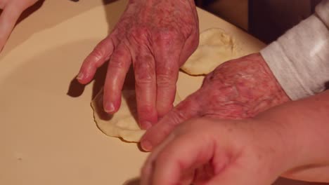 Senior-hands-kneading-raw-dough-in-slow-motion