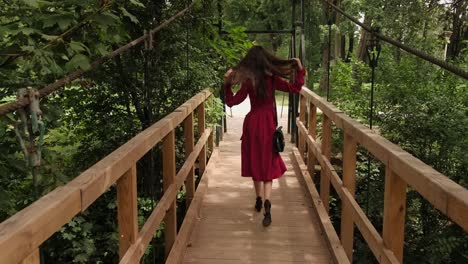 Pleasing-girl-crosses-the-bridge-and-walks-in-the-park