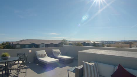 A-beautiful-roof-deck,-overlooking-a-neighborhood-in-Las-Vegas,-Nevada,-setup-to-be-a-perfect-chillout-space---Wide-pan-shot