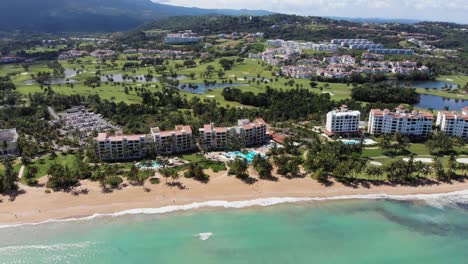 Puerto-Rico-coastline-with-tourist-hotels,-golf-course-and-stunning-beach