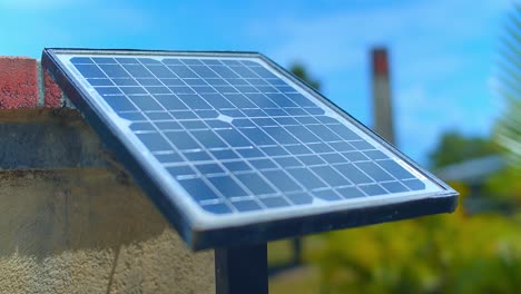 Small-Solar-Panel-Mounted-to-a-wall-in-a-yard