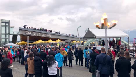 Pan-of-people-at-Jack-Poole-Plaza-watching-the-relit-Vancouver-olympic-cauldron-at-ten-year-celebration