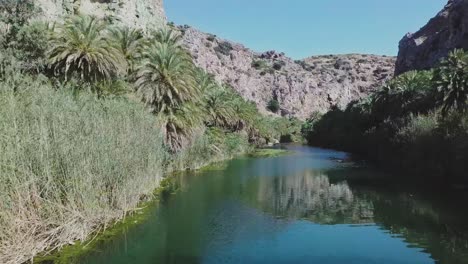 Drone-flying-low-backwards-Preveli-Crete