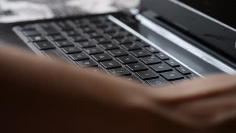 A-closeup-up-shot-of-a-user-sanitizing-their-laptop-keyboard-as-a-precaution-to-curb-spreading-of-corona-virus