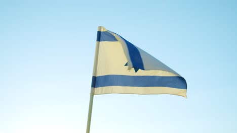 The-Israeli-flag-flapping-in-the-wind-during-a-clear-day