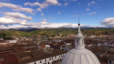 Aerial-shot-descending-from-panoramic-view-of-Popayan,-Colombia,-to-church-basilica-on-central-square