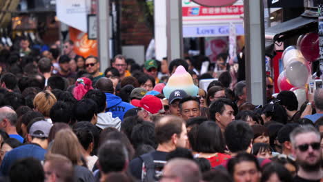 Slow-motion-shot-of-a-large-group-of-people,-walking-on-the-crowded-streets-of-Harajuku,-in-Shibuya,-Tokyo,-Japan