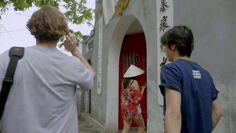 Hanoi,-Vietnam---A-family-of-tourist-passing-beside-an-infrastructure-towards-the-waterfront---close-up