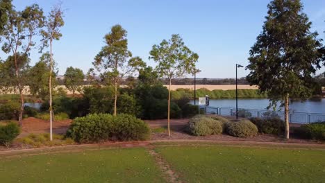 aerial-Pan-across-tree-front-past-wetlands-and-farming-fields