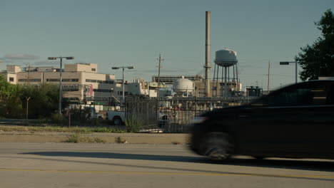 Factory-with-Cars-in-Foreground