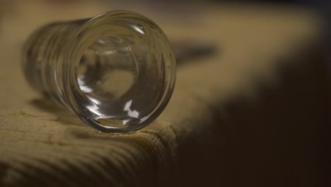 glass-of-alcohol-dripping-over-table