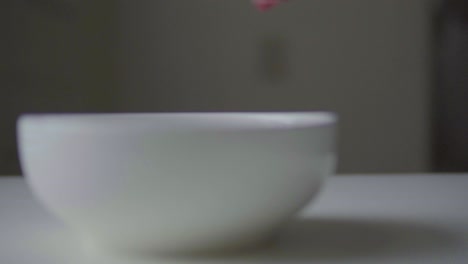 Candy-being-poured-into-white-bowl