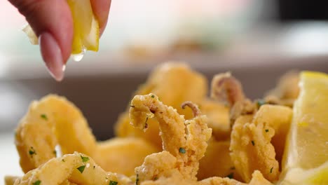 Squizing-lemon-juice-on-fried-shrimps