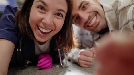 First-person-view-of-happy-girl-veterinarian-and-pet-owner-man-smiling-and-looking-into-the-eyes-of-his-pet-taking-it-out-of-his-carrier-in-a-veterinary-clinic