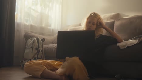 Sad-blonde-girl-in-a-black-T-shirt-closes-her-laptop-after-watching-movies-all-night