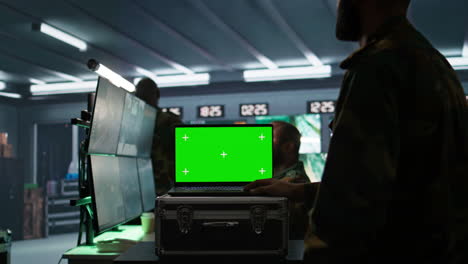 Soldier-using-tracking-software-on-green-screen-laptop-to-gain-info-against-enemies