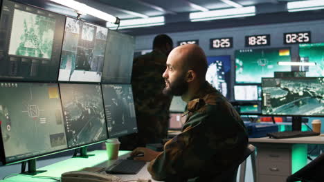 Man-looking-at-screens-in-military-HQ-base-intercepting-ballistic-rockets